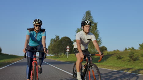 Tracking-shot-of-a-group-of-cyclists-on-country-road.-Fully-released-for-commercial-use.